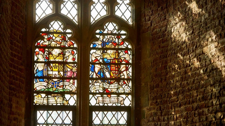 Sunlight illuminating a heraldic stained glass window at Tattershall Castle, Lincolnshire